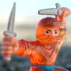 Tom — a vintage orange ninja action figure, poised and ready